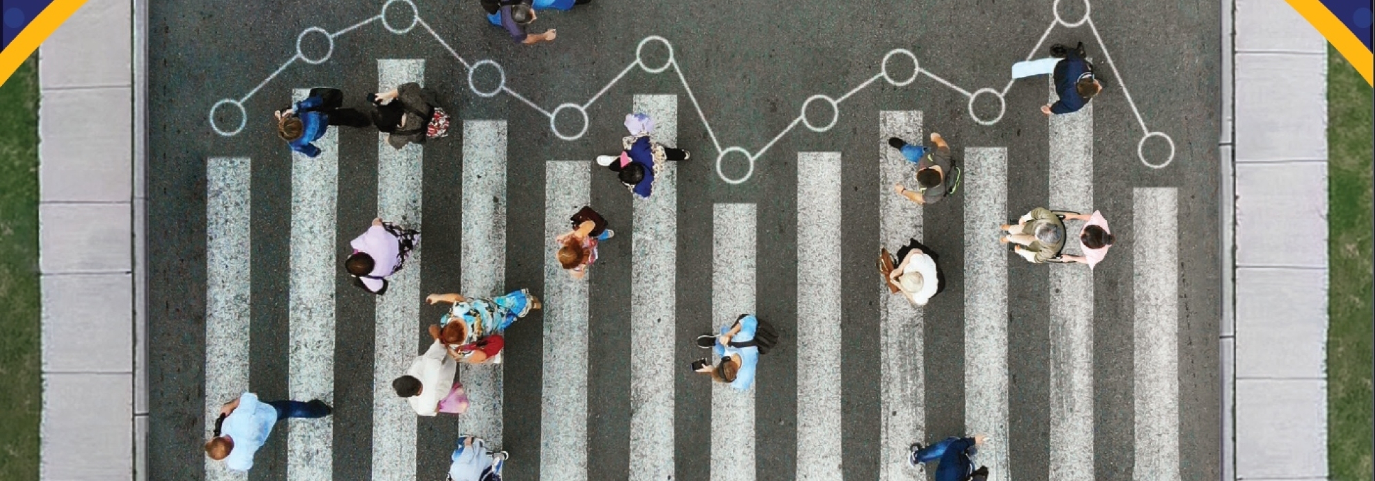 Aerial view of people walking through a crosswalk