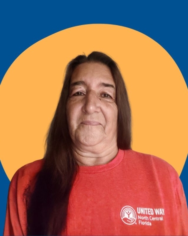 A person wearing a red t-shirt with the United Way North Central Florida logo.
