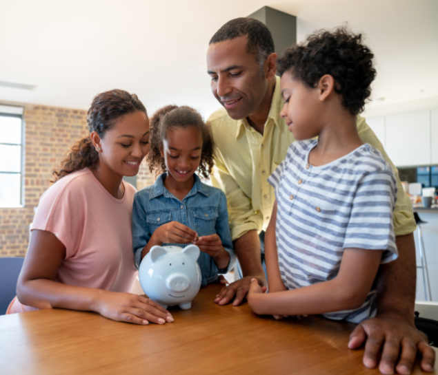 Family staring at a piggy bank